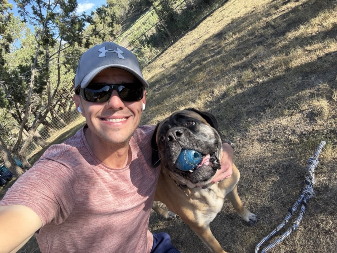 Snoutbook's creator outdoors with Freya, who has a ball in her mouth